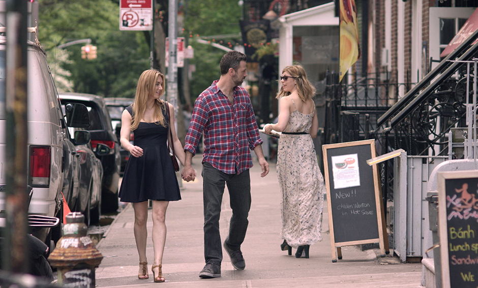 man and woman walking down street