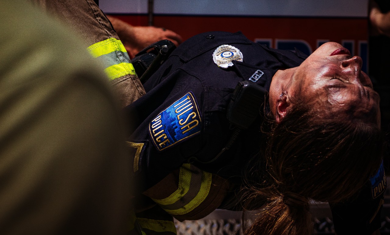 police officer being carried by fireman